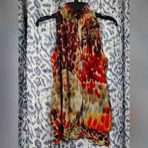 Ruffled collar sleeveless blouse with floral embellishments